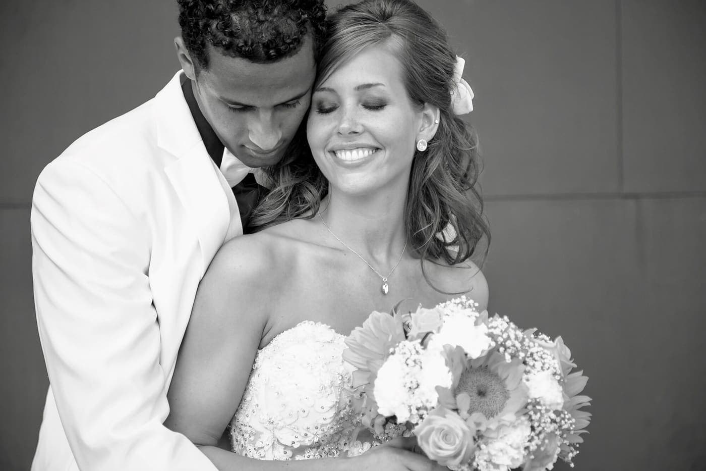 Axe and Laura Ahmed on their wedding day, in black and white